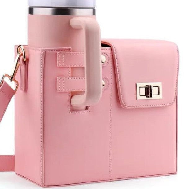 Pink leather water bottle bag with a flap pocket, gold-tone hardware, and attached tumbler.
