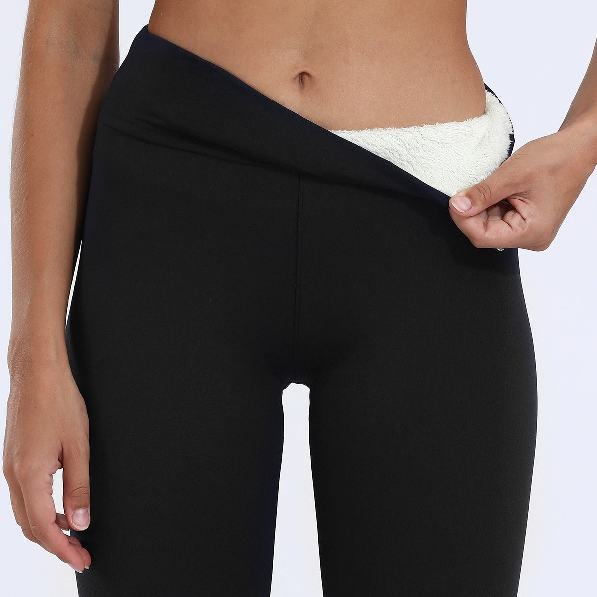 Black fleece-lined high-waisted leggings with smooth exterior and white fuzzy interior lining.