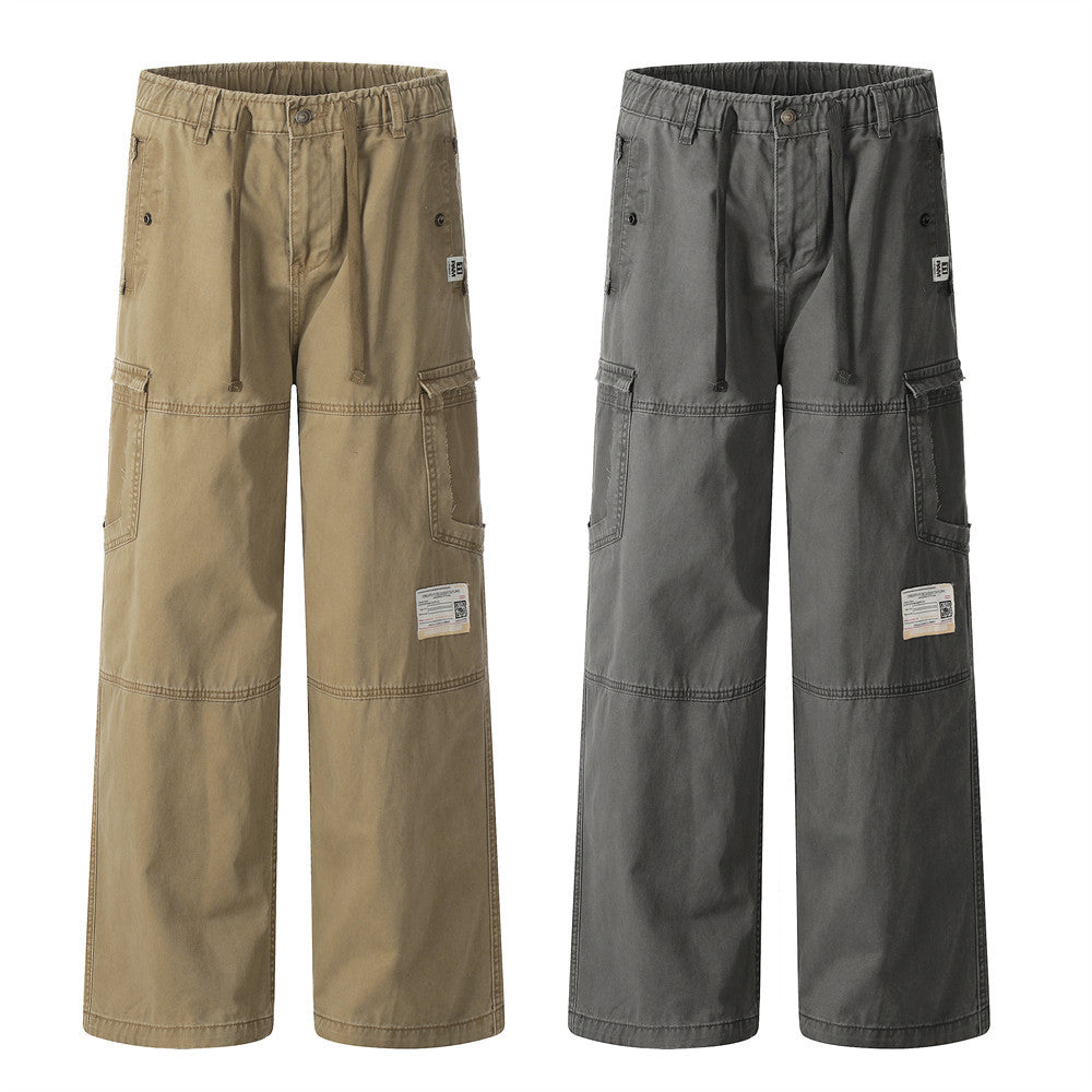 Two pairs of cotton cargo pants in khaki and grey feature elastic waistbands, drawstrings, side pockets, and labels.