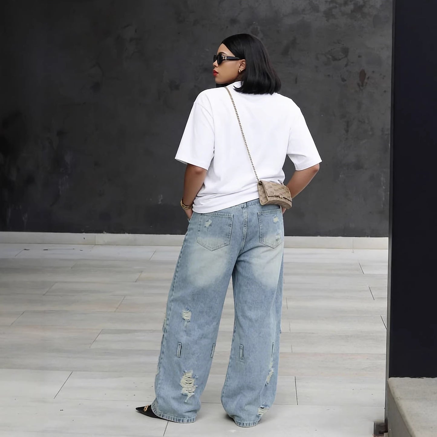 Light wash distressed ripped knee denim jeans by Plush Fashion Hub, showcasing a trendy, casual fit with faded detailing and frayed knees.