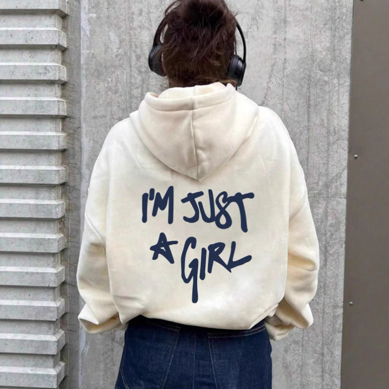 Cream hoodie with dark blue handwritten text "I'm Just A Girl" on the back.