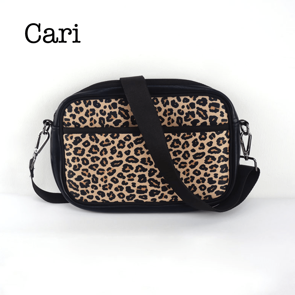 Black neoprene crossbody bag by Threaded Pear with adjustable strap and minimalist design.