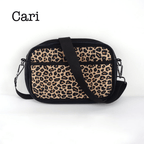 Black neoprene crossbody bag by Threaded Pear with adjustable strap and minimalist design.