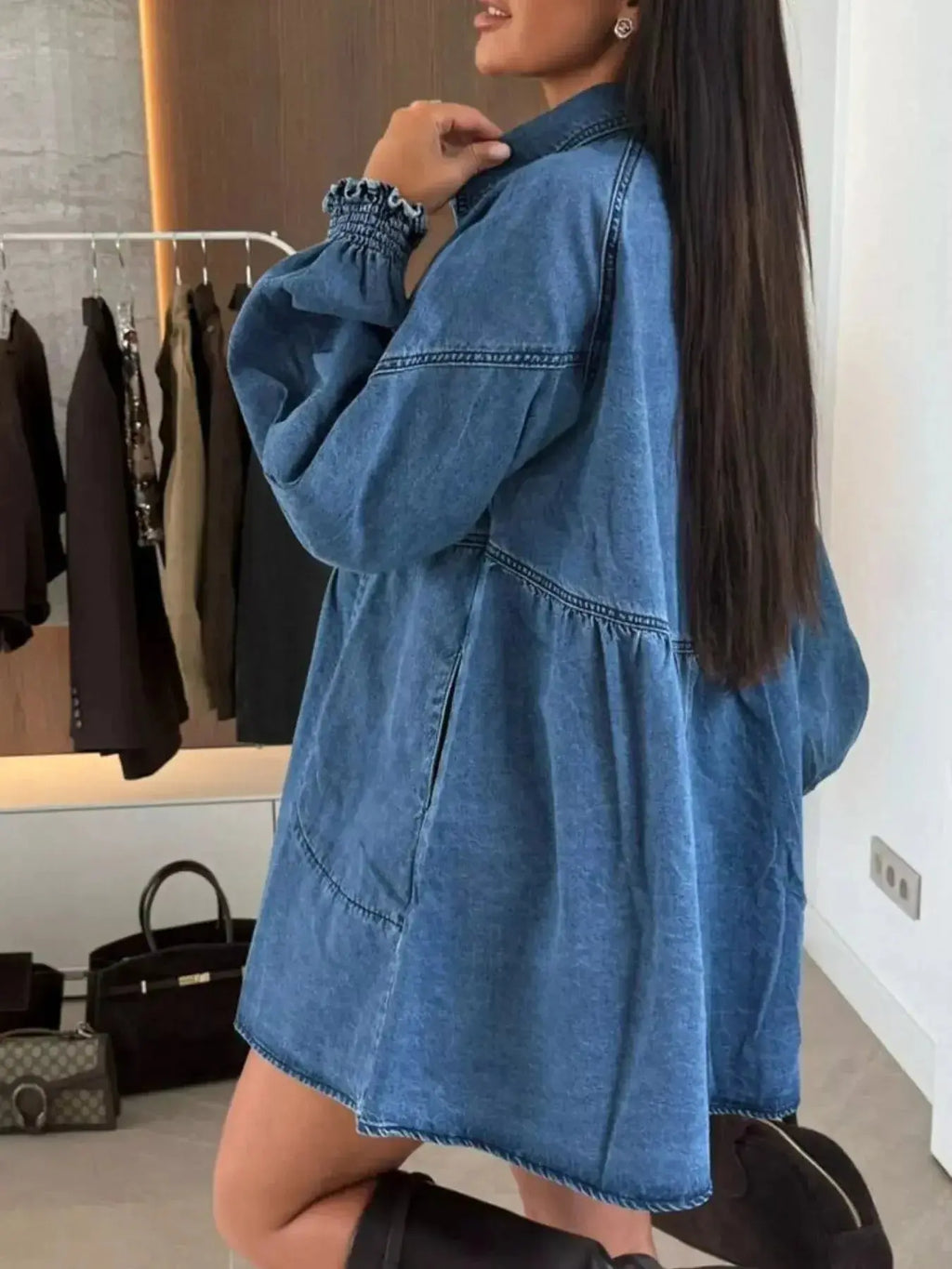 Casual mini denim dress with front pockets, button-down style by Trendsi, displayed on a hanger, perfect for everyday wear.