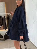 Casual button-down mini denim dress with front pockets by Trendsi, featuring a classic denim fabric and relaxed fit.