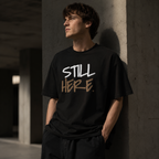 Wear Your Worship Still Here Tee, motivational streetwear shirt with mental health and resilience graphic design.