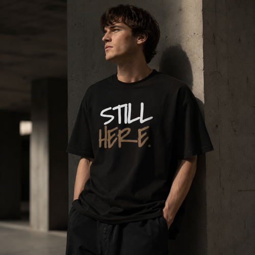 Wear Your Worship Still Here Tee, motivational streetwear shirt with mental health and resilience graphic design.