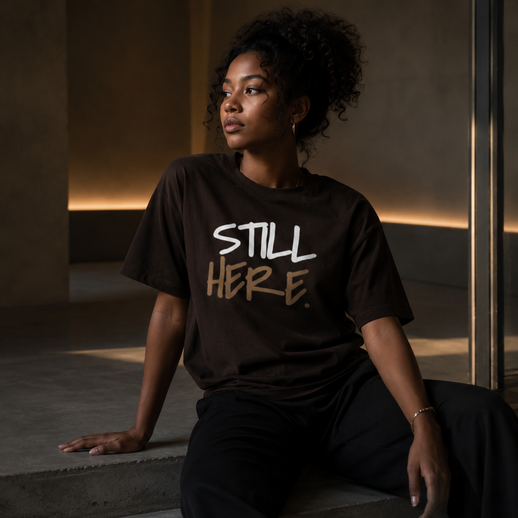 Wear Your Worship Still Here T-Shirt featuring motivational mental health and resilience graphic design.
