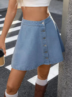 Light blue denim A-line skirt with button-front closure and pockets, styled for casual wear, from Trendsi's Plush Fashion Hub.