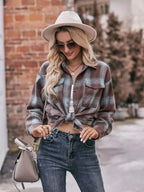 Women’s classic plaid long sleeve button-down shirt by Trendsi, featuring a timeless checkered pattern and tailored fit.