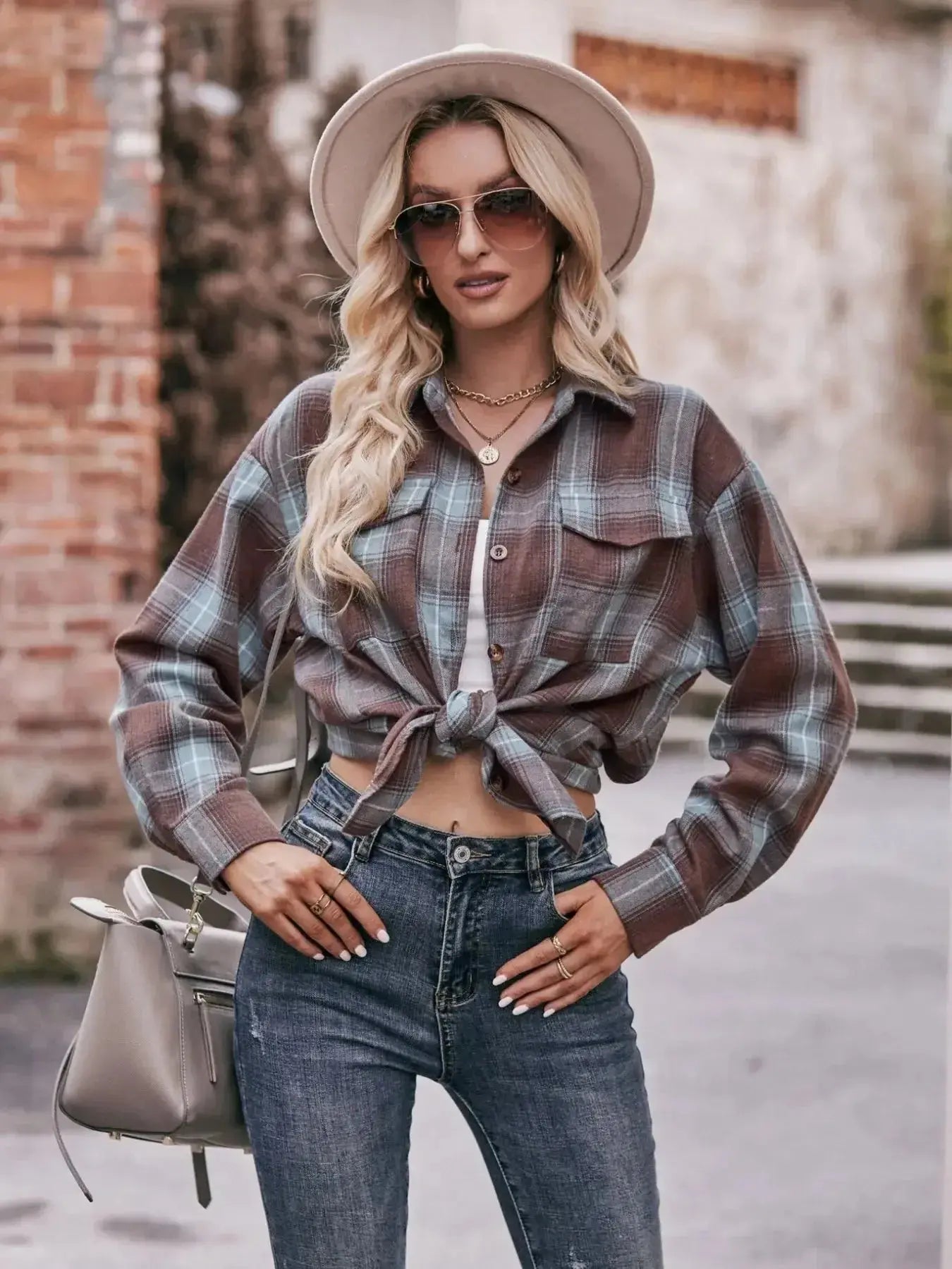 Women’s classic plaid long sleeve button-down shirt by Trendsi, featuring a timeless pattern and casual fit.