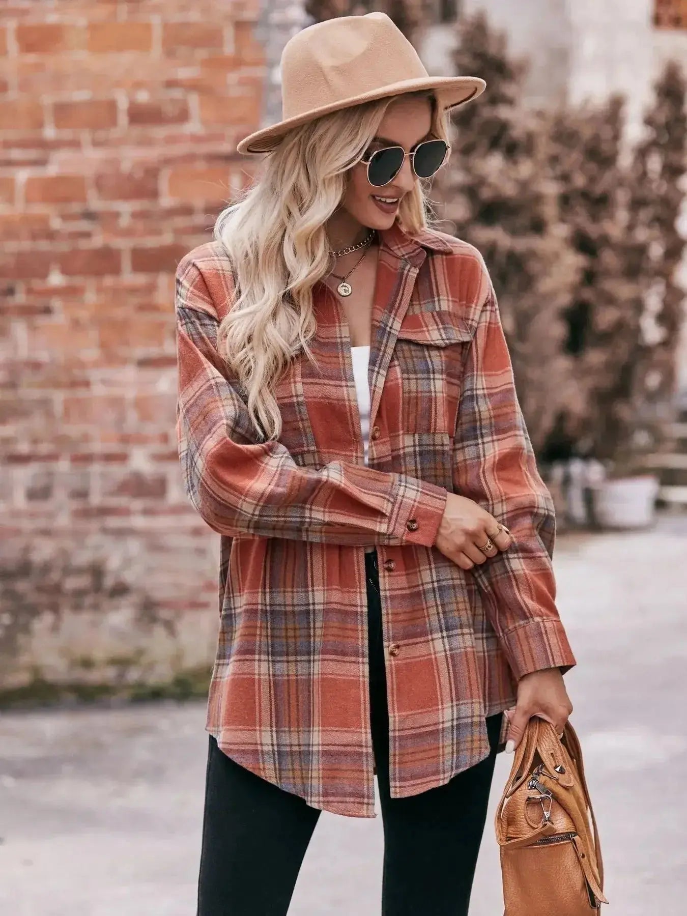Women’s classic plaid long sleeve button-down shirt by Trendsi, featuring a stylish checkered pattern and collar detail.