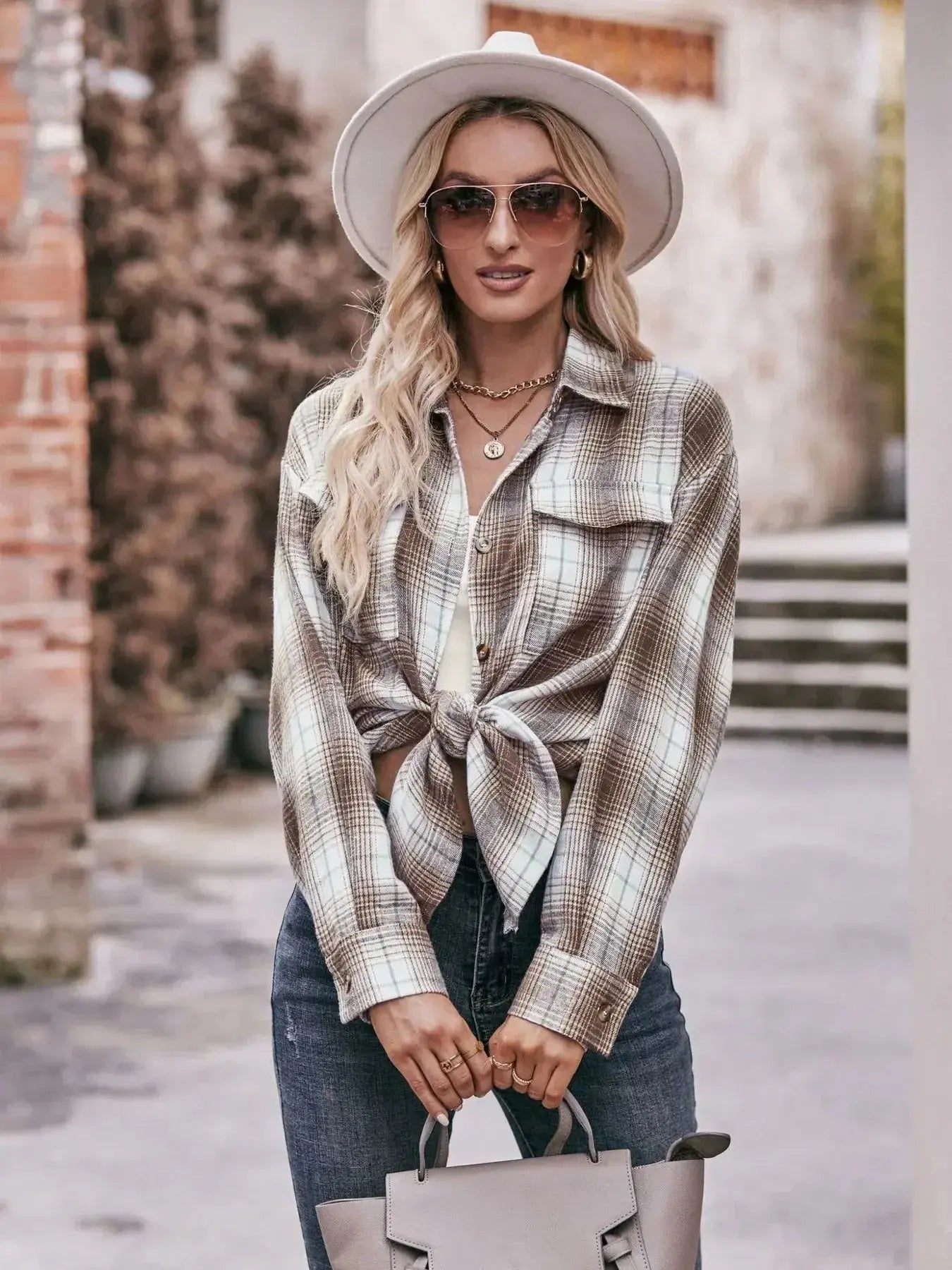 Women’s classic plaid long sleeve button-down shirt by Trendsi, featuring a traditional checkered pattern and collared neckline.