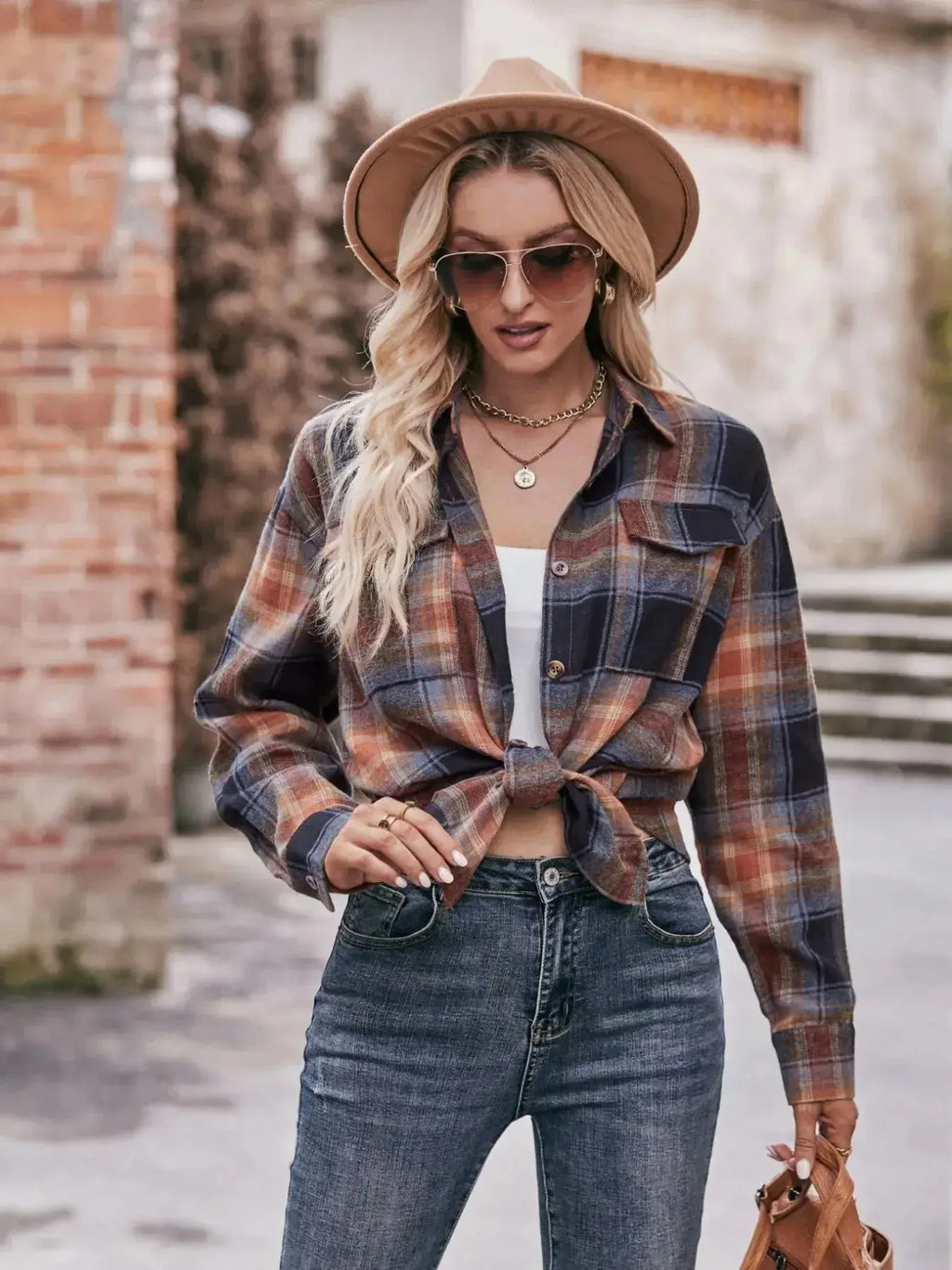 Women’s classic plaid long sleeve button-down shirt by Trendsi, featuring a timeless pattern and tailored fit.