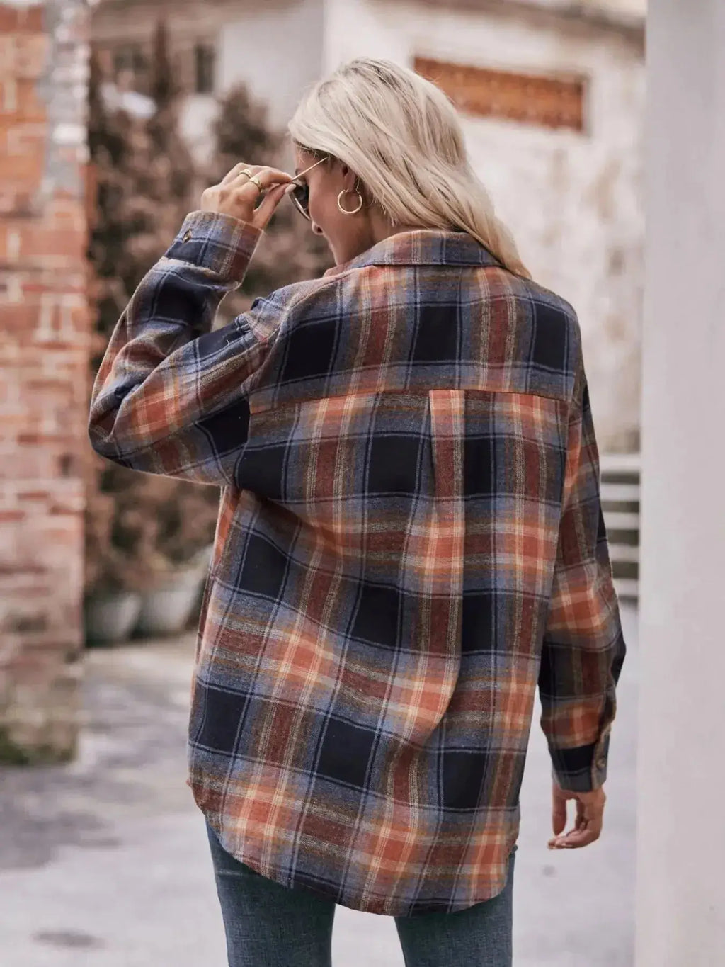 Women’s classic plaid long sleeve button-down shirt by Trendsi, featuring a timeless pattern and casual fit.