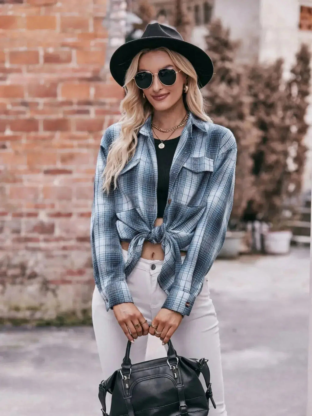 Women’s classic plaid long sleeve button-down shirt by Trendsi, featuring a stylish checkered pattern and collar detail.