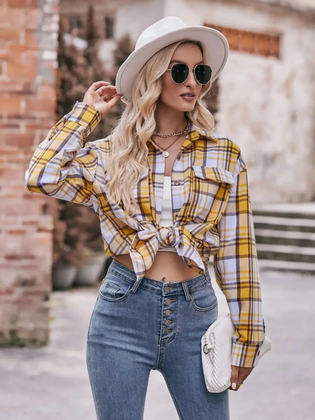 Women’s classic plaid long sleeve button-down shirt by Trendsi, featuring a timeless pattern and casual fit.