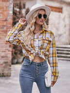 Women’s classic plaid long sleeve button-down shirt by Trendsi, featuring a timeless pattern and casual fit.