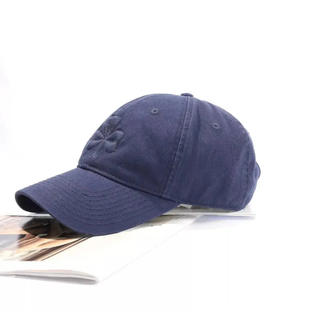 Clover embroidered 100% cotton baseball cap by Trendsi, breathable casual hat with a relaxed fit and stylish embroidered clover detail.