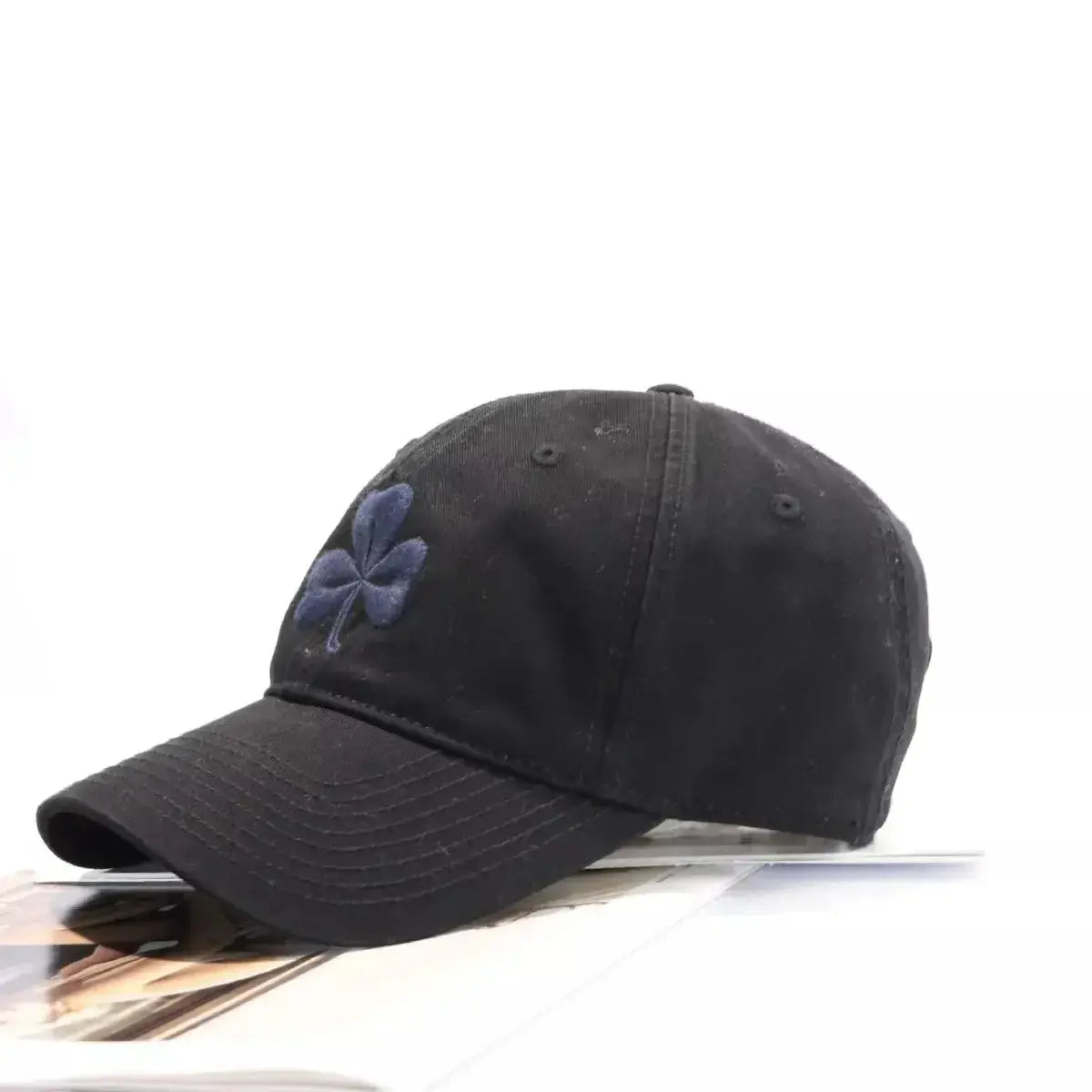 Clover embroidered 100% cotton baseball cap by Trendsi, breathable casual hat with adjustable strap and curved brim.