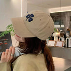 Clover embroidered 100% cotton baseball cap by Trendsi, breathable casual hat with adjustable strap and stylish embroidery detail.