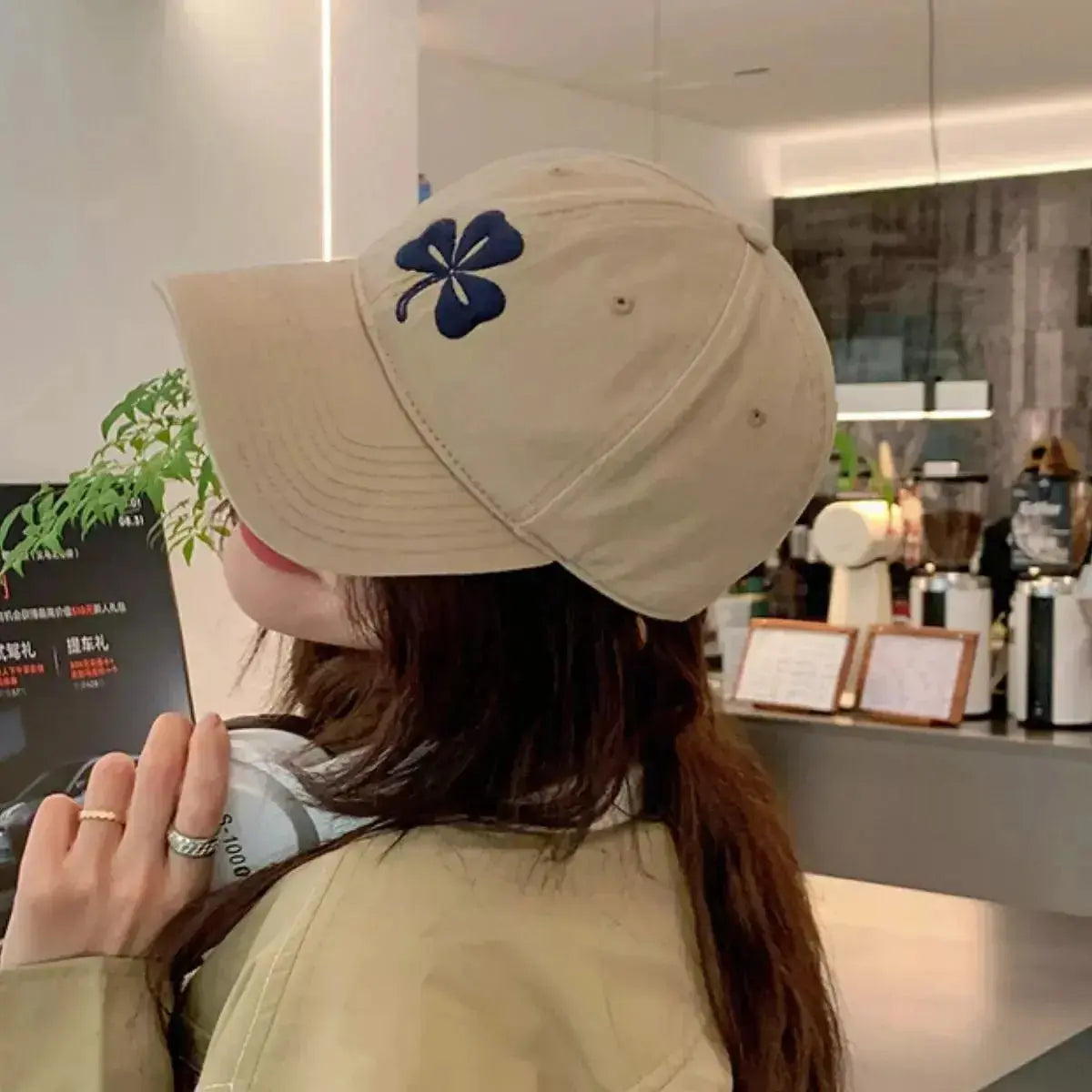 Clover embroidered 100% cotton baseball cap by Trendsi, breathable casual hat with adjustable strap and stylish embroidery detail.