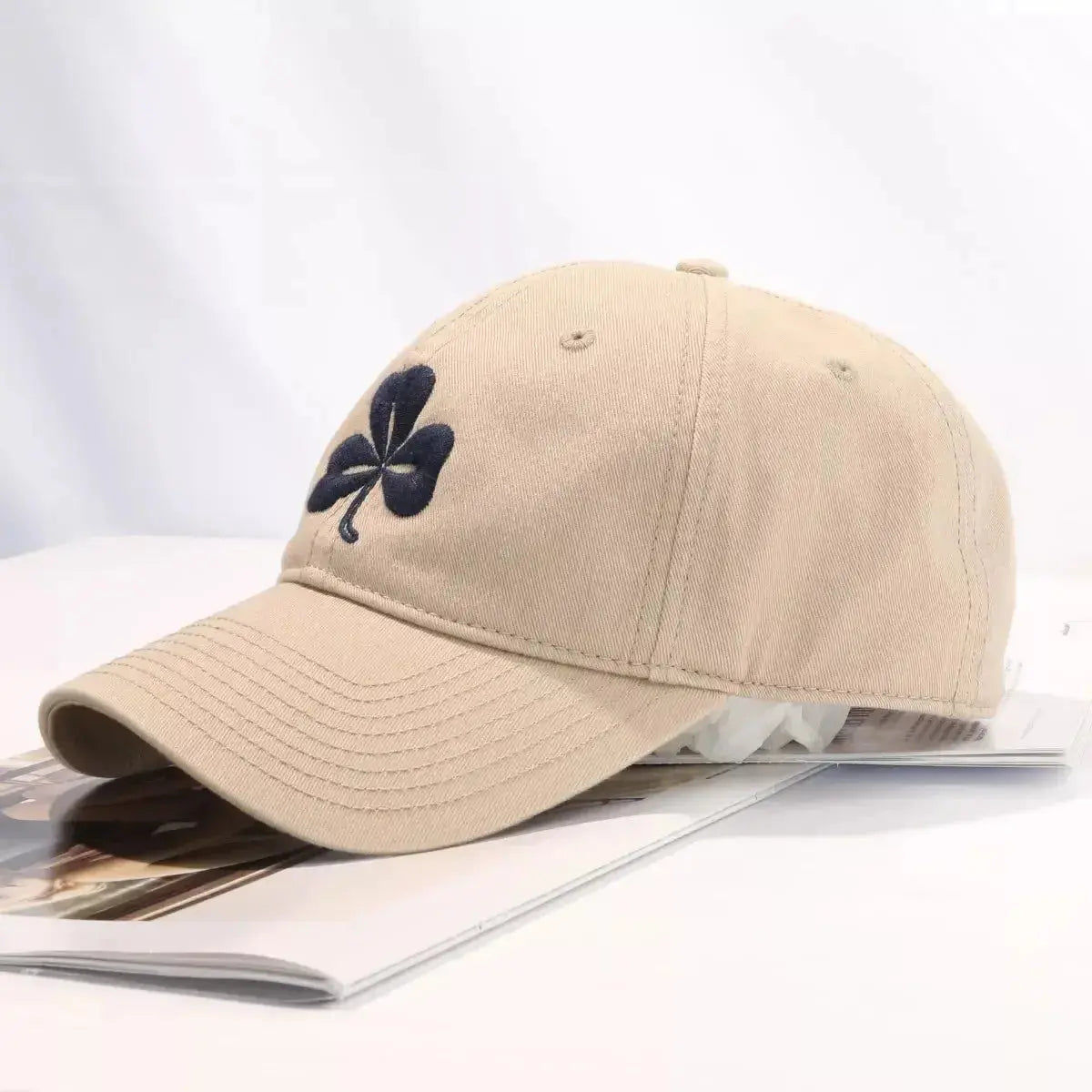 Clover embroidered 100% cotton baseball cap by Trendsi, breathable casual hat with a stylish embroidered clover design.