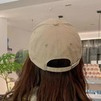 Clover embroidered 100% cotton baseball cap by Trendsi, breathable casual hat with a classic curved brim and adjustable strap.