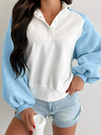 Women's color block sweatshirt with snap buttons, soft cotton blend pullover by Plush Fashion Hub, featuring vibrant contrasting panels.