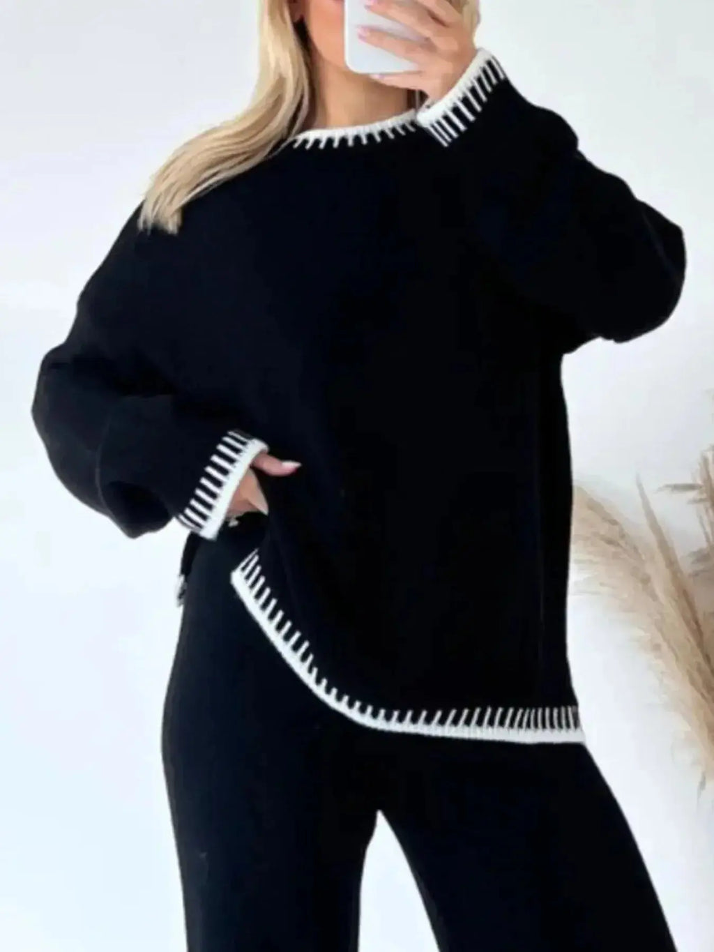 Contrast trim round neck sweater top and wide-leg pants lounge set by Trendsi, featuring a cozy, stylish matching ensemble.