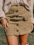 Women's high-waisted corduroy mini skirt with button-front closure by Plush Fashion Hub, shown in a stylish, textured fabric.