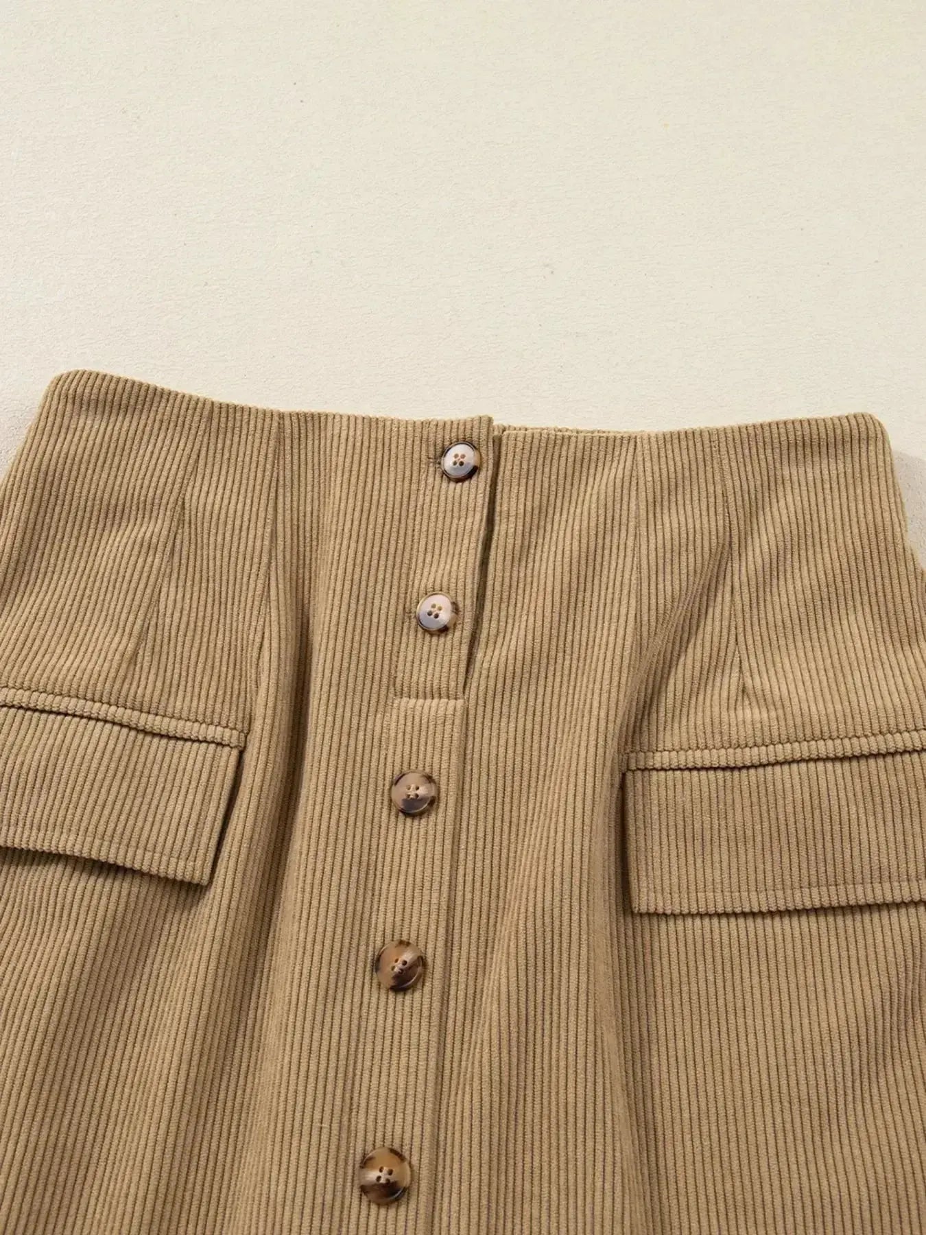 Women's high-waisted corduroy mini skirt with button front from Plush Fashion Hub, shown in a stylish, close-up view.