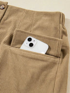 Women's high-waisted corduroy mini skirt with button-front closure from Plush Fashion Hub, shown in a stylish, textured fabric.