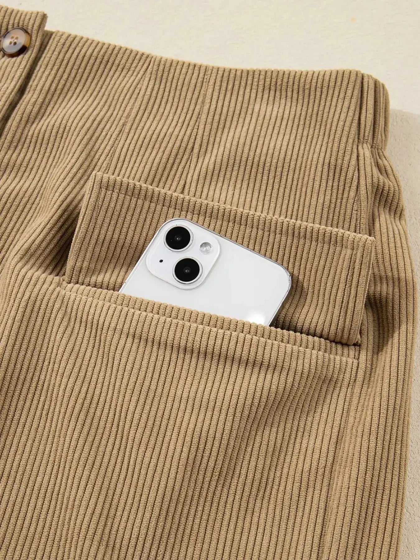 Women's high-waisted corduroy mini skirt with button-front closure from Plush Fashion Hub, shown in a stylish, textured fabric.