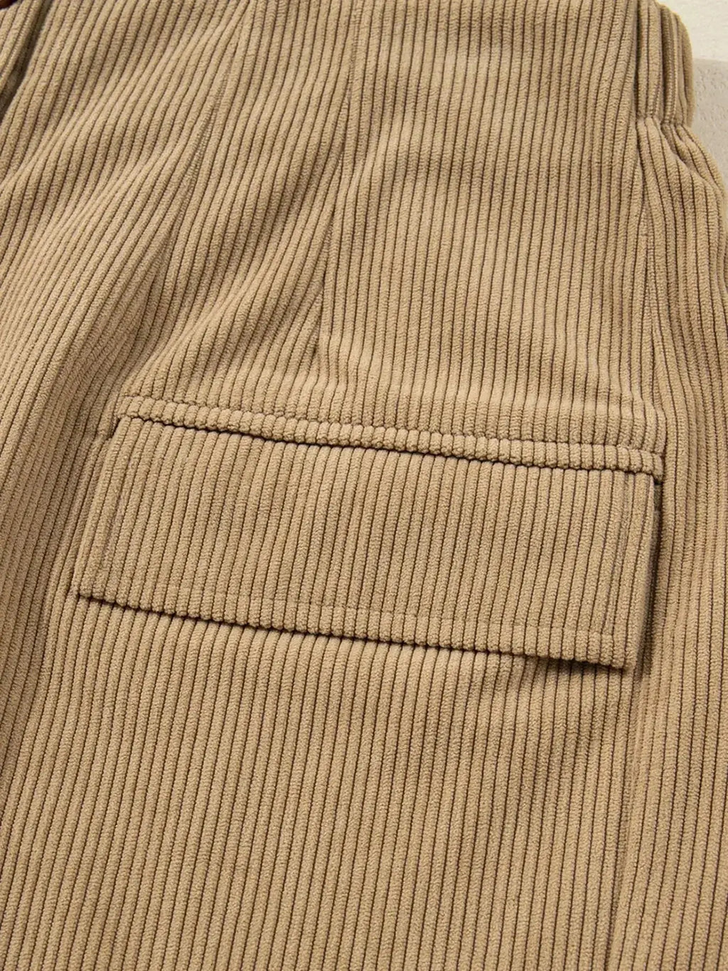 Women's high-waisted corduroy mini skirt with button front from Plush Fashion Hub, showcasing a stylish and trendy design.