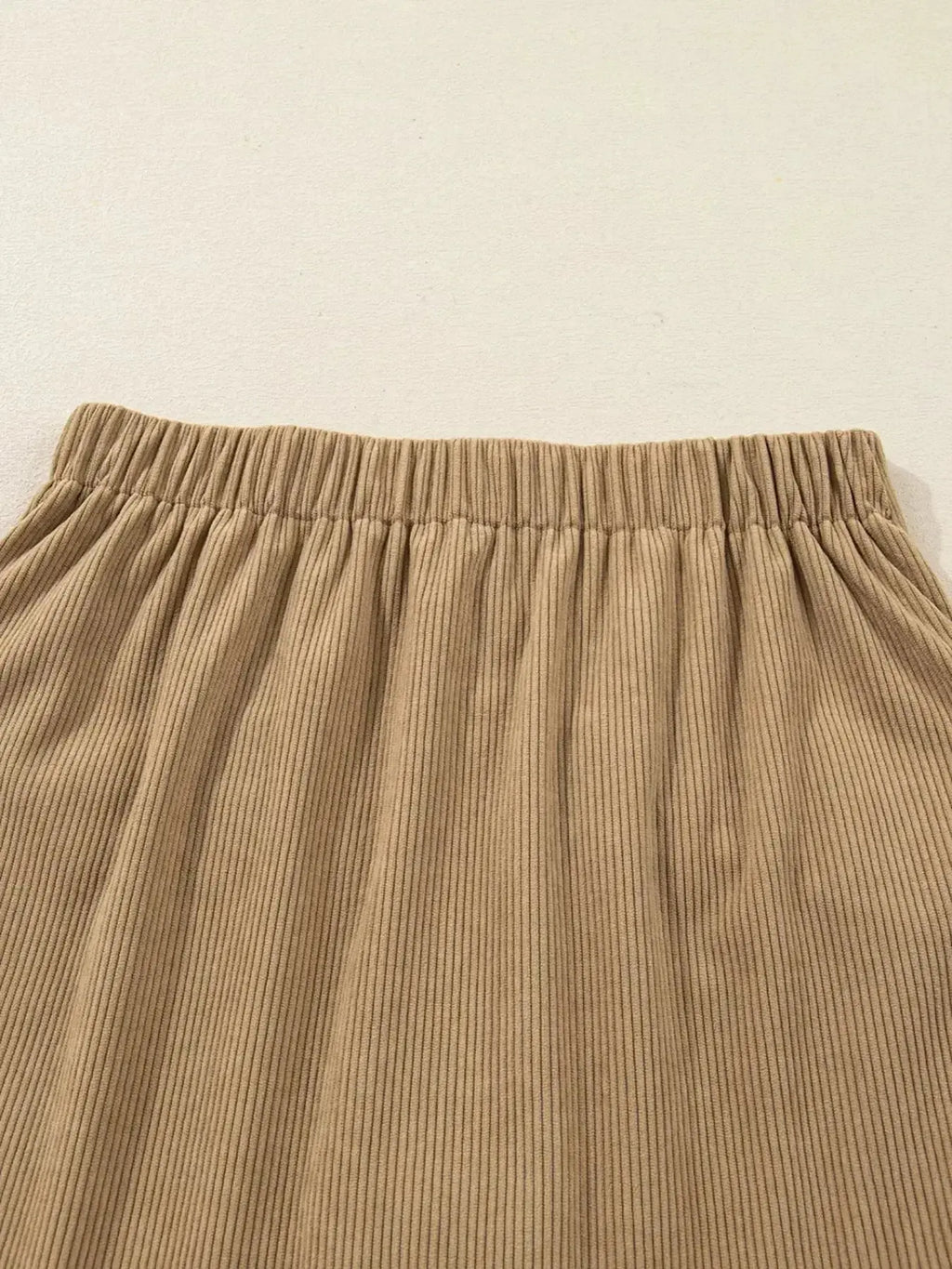 Women's high-waisted corduroy mini skirt with button front in a stylish, textured design by Plush Fashion Hub.