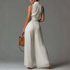 FitiqueFit sleeveless pleated wide-leg high-waist jumpsuit for women, minimalist long jumpsuit with a relaxed fit and elegant style.