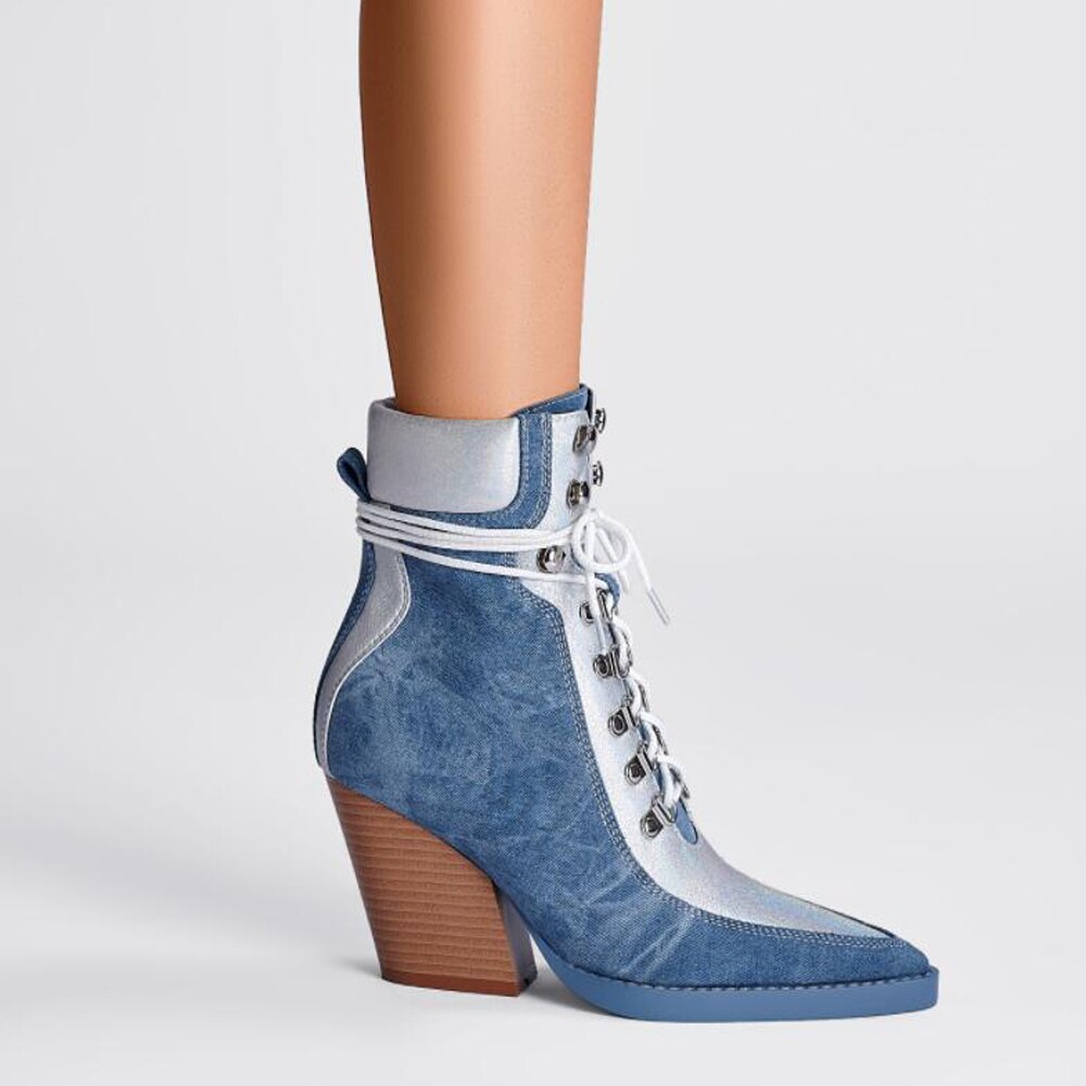 Blue denim and silver ankle boot with white laces, pointed toe, wooden block heel, and metal eyelets.