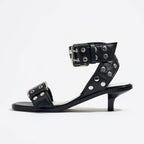 Eprolo rivet accent mid-heel strappy sandals with open toe and ankle straps, featuring fashionable rivet details.