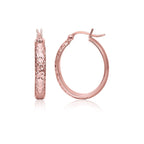 14k rose gold hammered oval hoop earrings showcasing shiny, textured surface on a jewelry display.