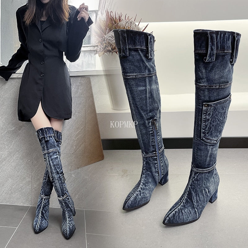 Dark blue denim over-the-knee boots with pointed toes, block heels, side pockets, and belt loops at the top.