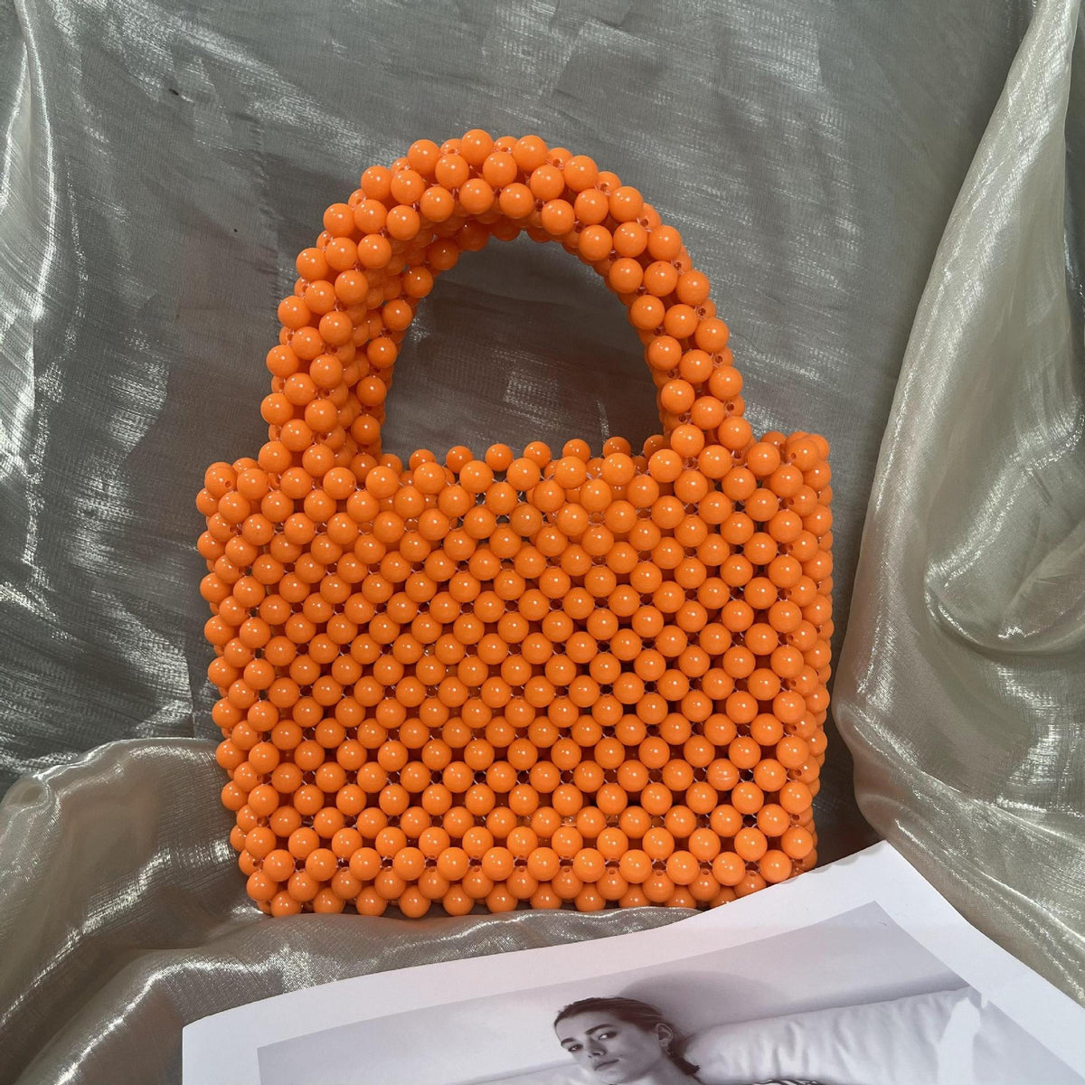 Beaded fashion handbag with solid color design and intricate beaded details, crafted by eprolo for stylish accessory.