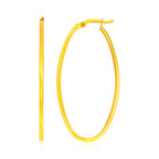 14k yellow gold slim oval hoop earrings with a sleek, minimalist design, perfect for elegant everyday wear.