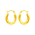 Polished 14k yellow gold oval hoop earrings with a smooth finish, crafted for elegant wear.