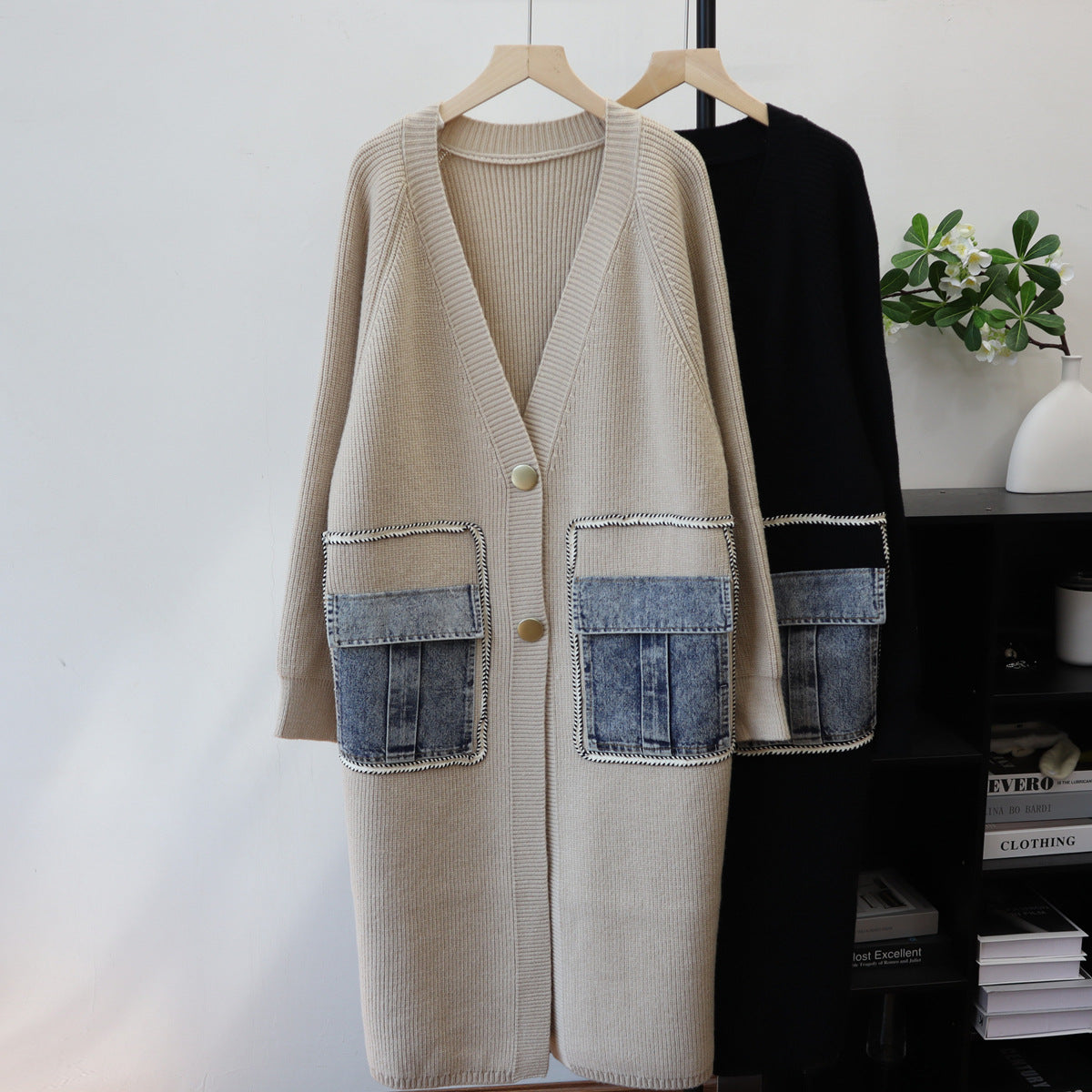 Beige knit long cardigan, V-neck, buttons, and contrasting denim patch pockets. Another black one behind.