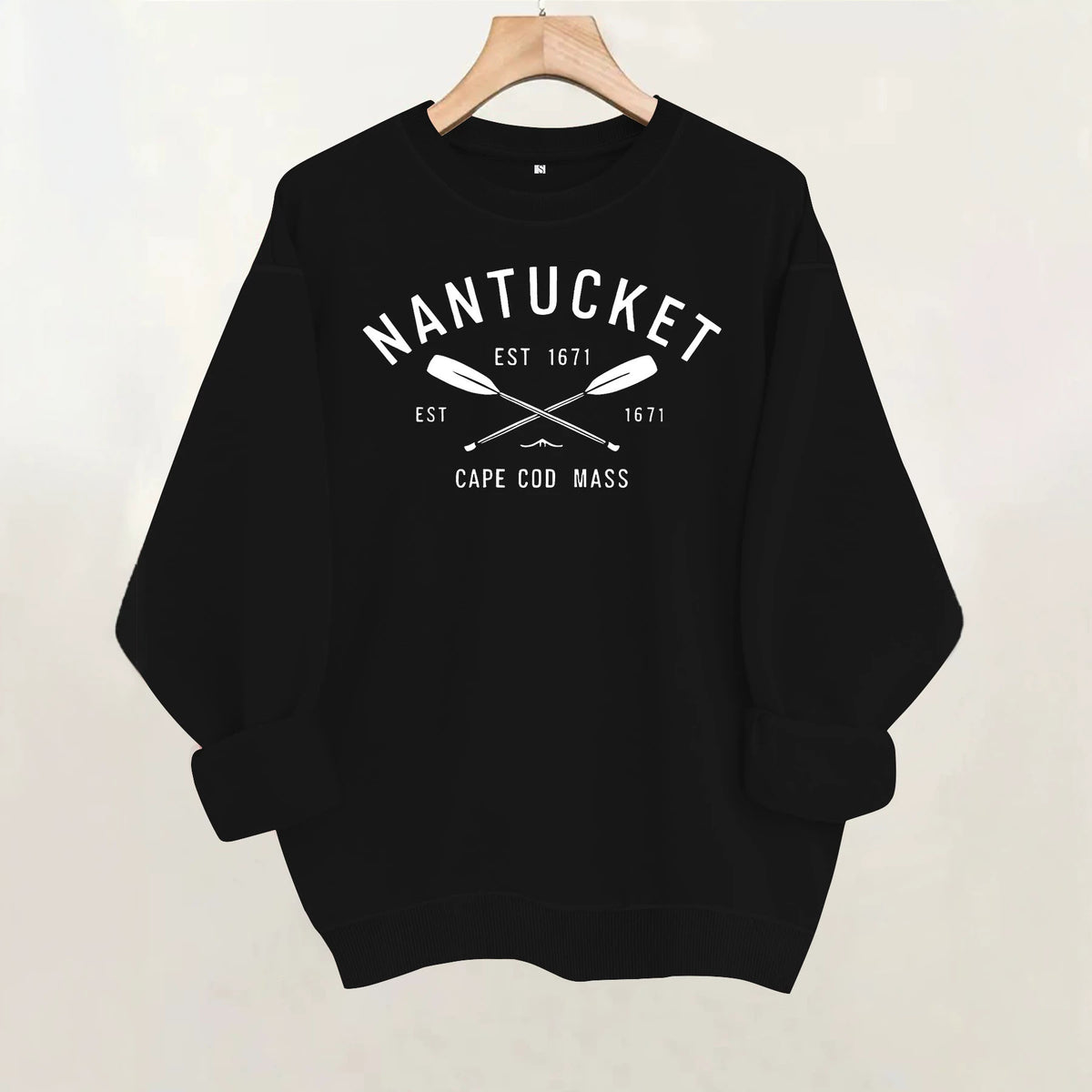 Black cotton crewneck sweatshirt with "Nantucket Est 1671 Cape Cod Mass" and crossed oars graphic on the chest.