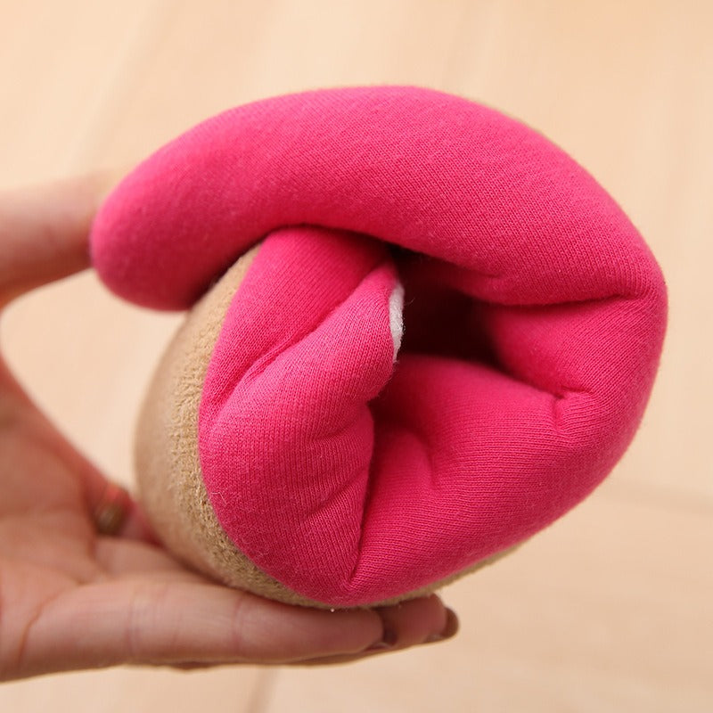 Hand holding a flexible, minimalist indoor slipper with a hot pink cotton interior and a tan suede-like outer sole.