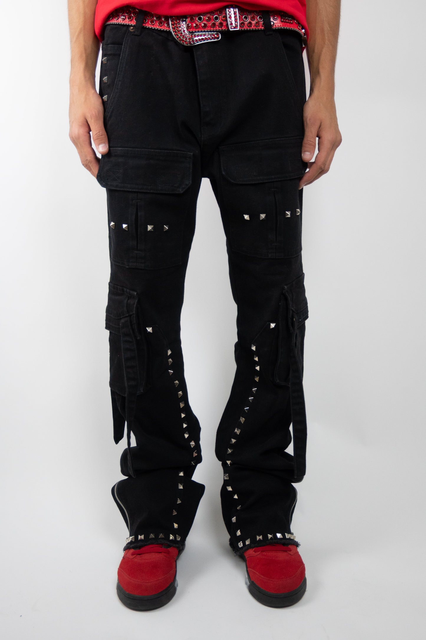 Stacked cargo jeans with studded accents from Plush Fashion Hub, featuring a relaxed fit and detailed stitching.