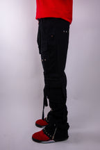 ARMOR JEANS studded stacked cargo jeans with multiple pockets and distressed details, shown on a hanger.
