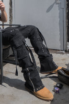 ARMOR JEANS RM206SK studded stacked cargo jeans with multiple pockets and distressed detailing, displayed on a hanger.